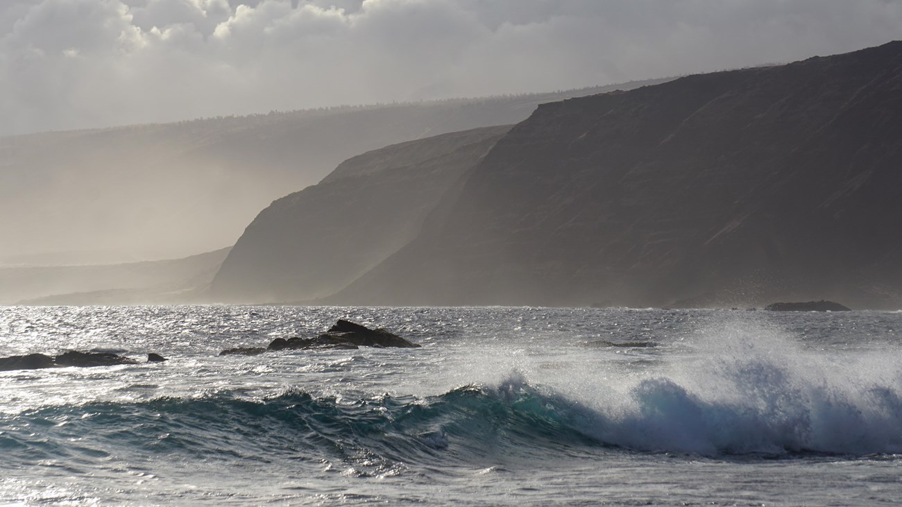 Ocean waves and coastal cliffs shortly before sunset