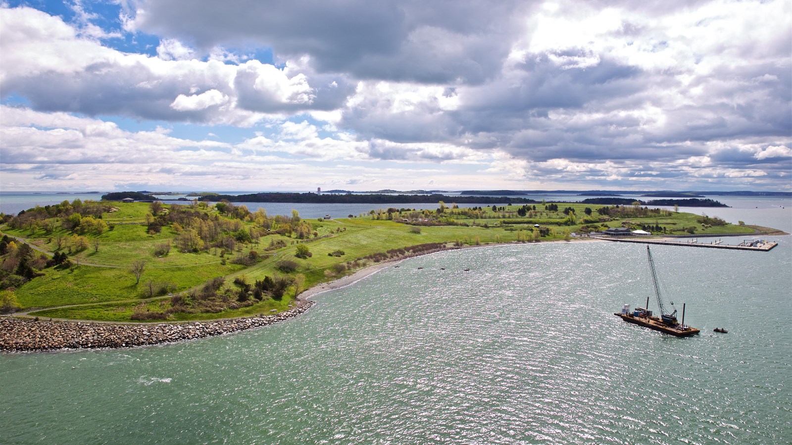 Island in the distance filled with shrubbery and trees. 