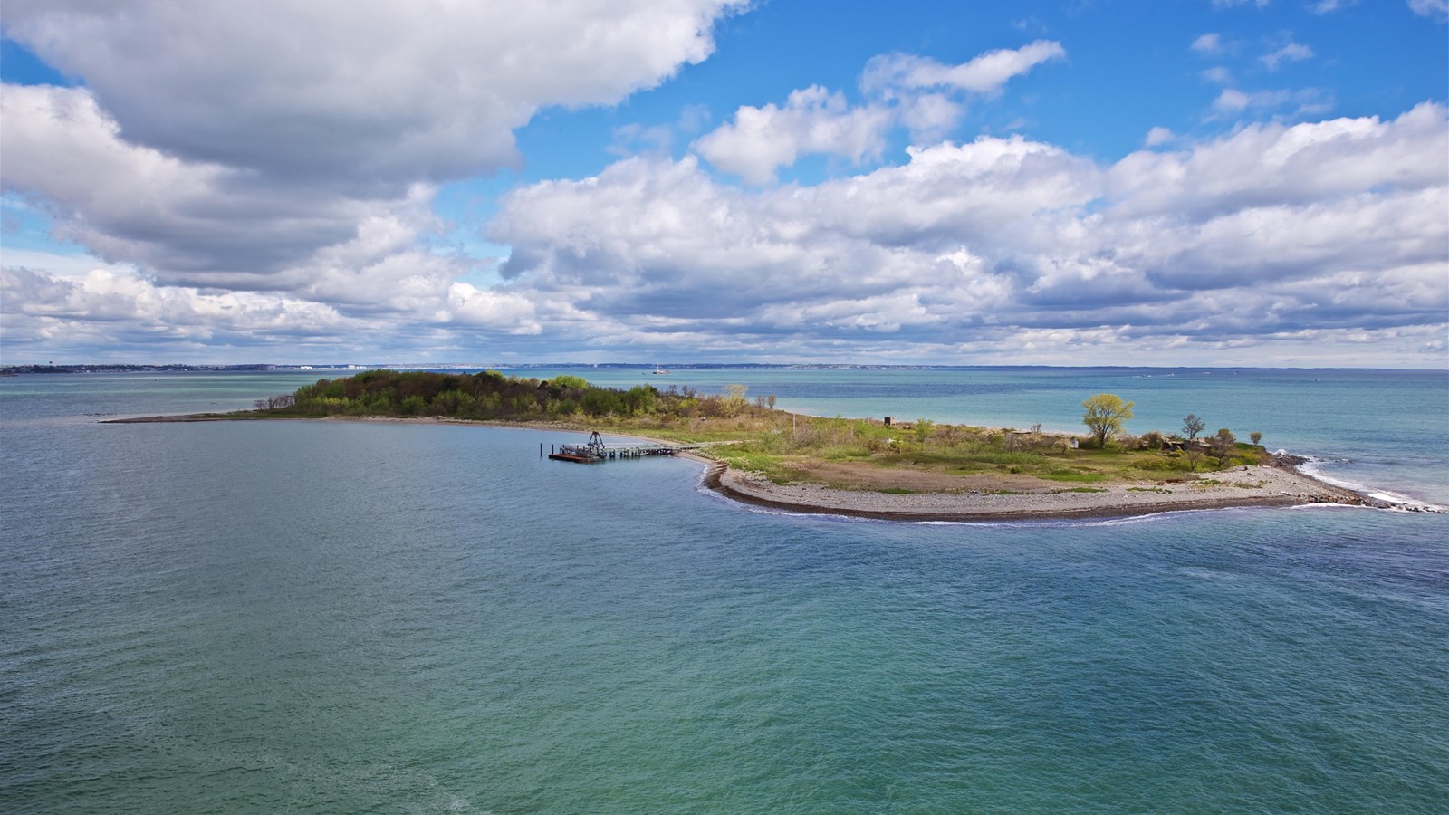 Photograph of Lovells Island from a distance surrounded by water. 