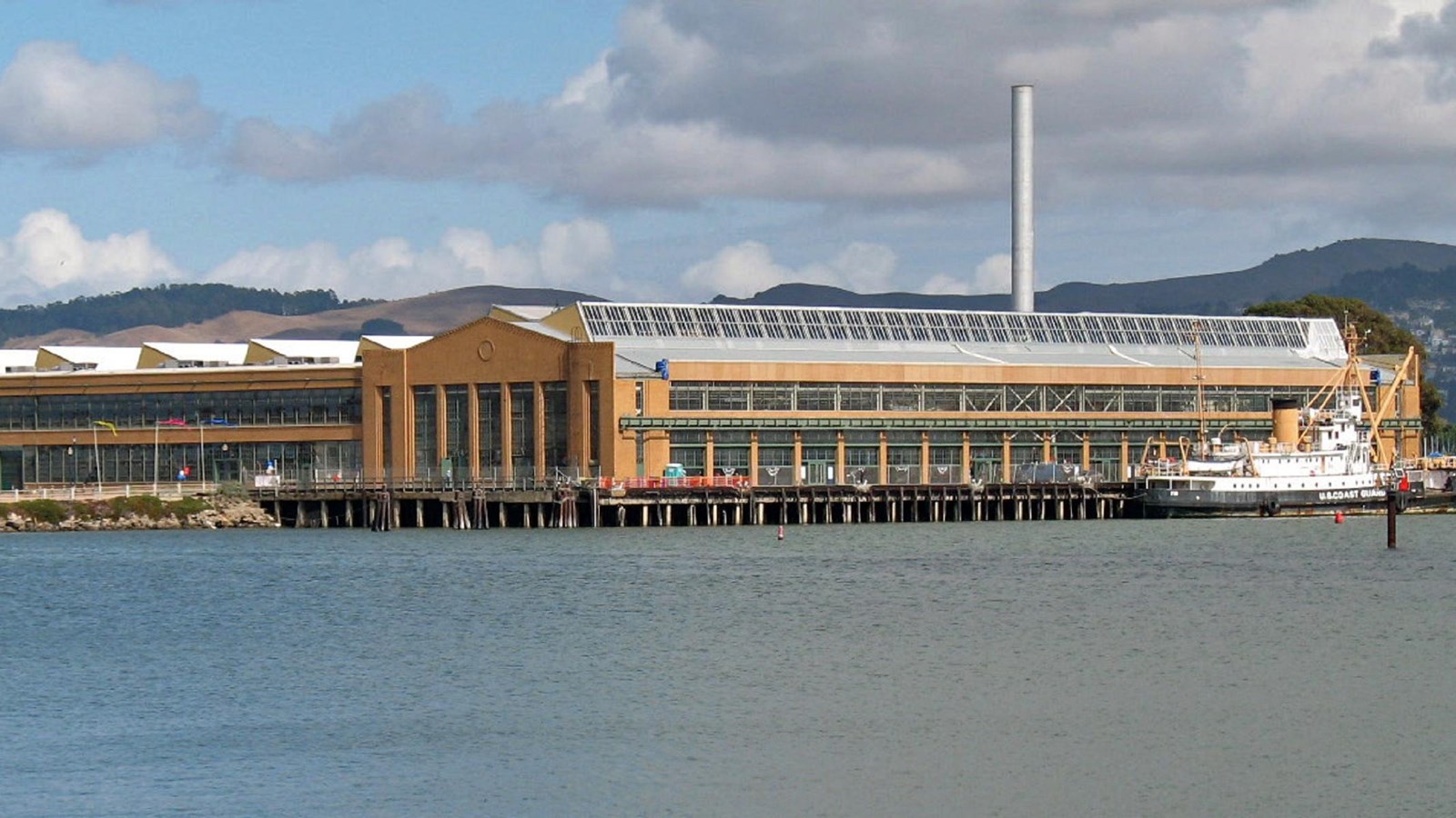 Photo of auto factory across the water. 