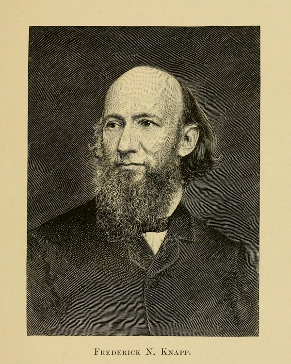 Bald man with long beard wearing 1800s clothing.