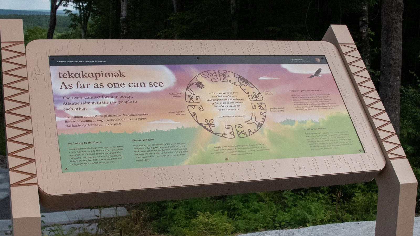 Outdoor exhibit panel with pink, green and yellow imagery.