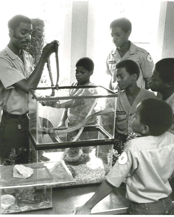 Ranger Mac showing Junior Rangers a snake