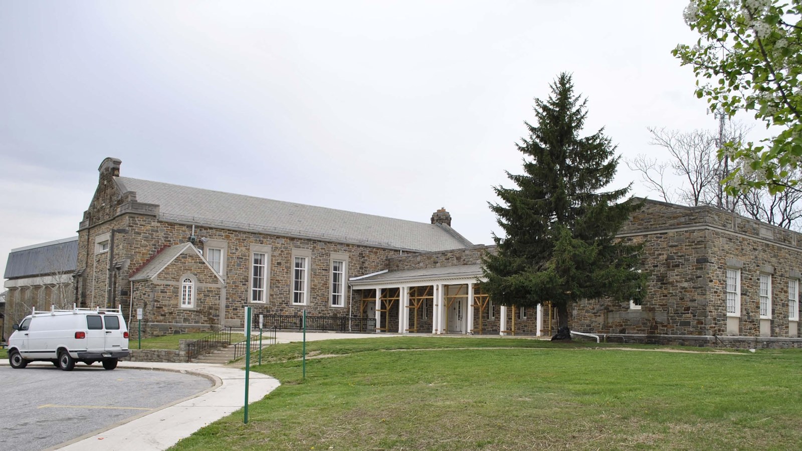 Large one-story masonry building with a smaller gable-roofed wing