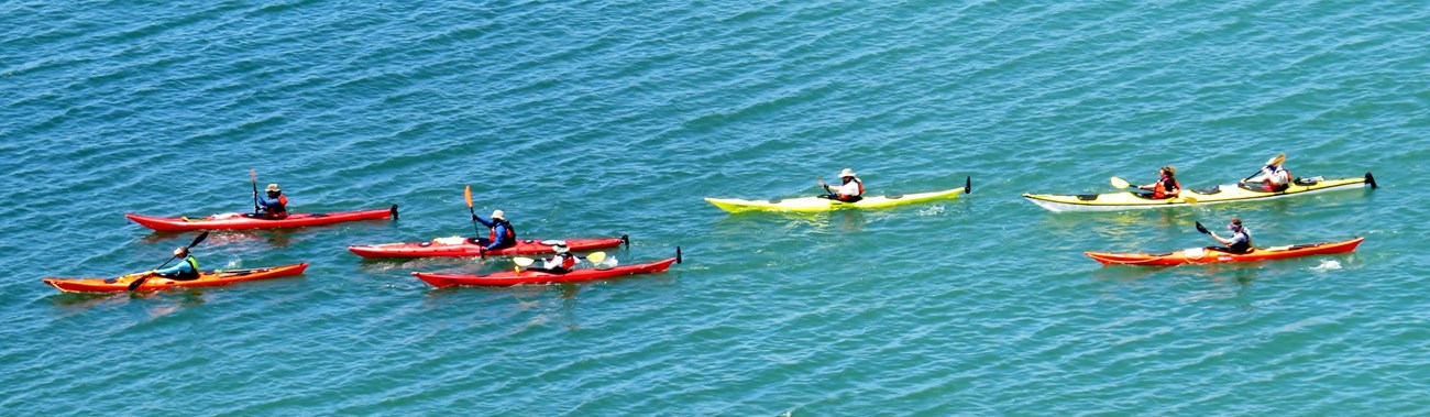 A group of kayakers paddle through the sound at Cape Lookout National Seashore.