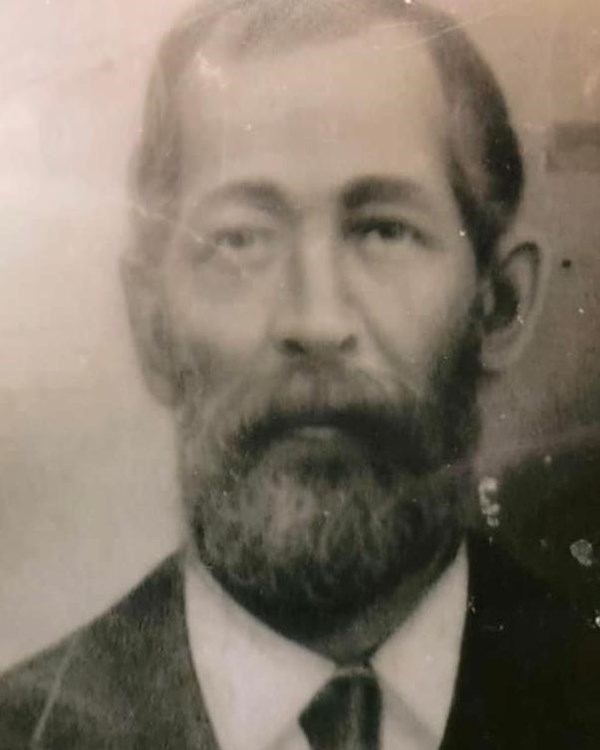 B&W Portrait of middle aged Mulatto man with mustache and beard wearing suit and tie.