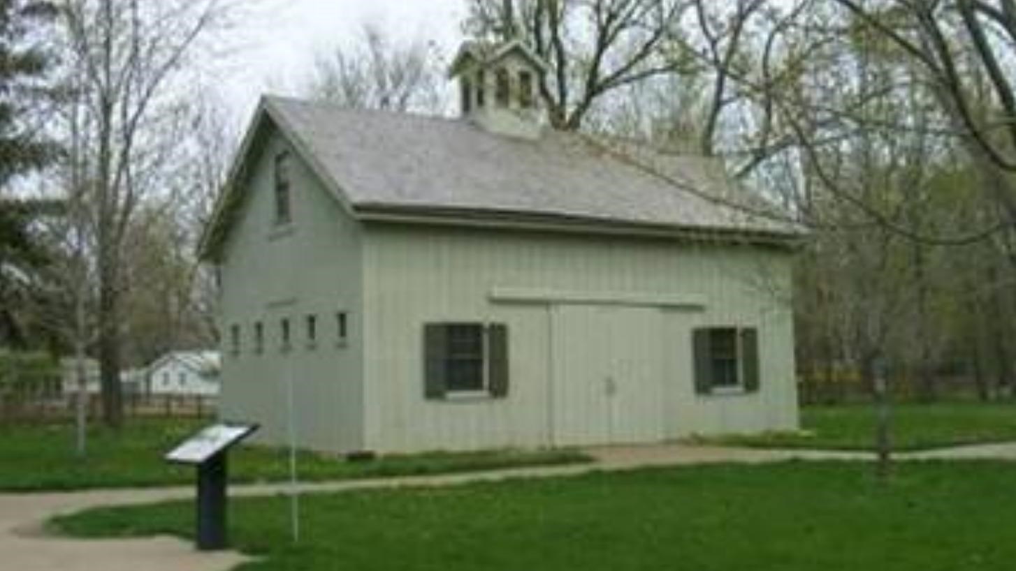 a beige building that looks like a barn from the outside