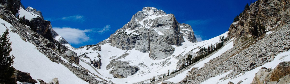 Middle Teton rises out of the center of a snowy canyon.