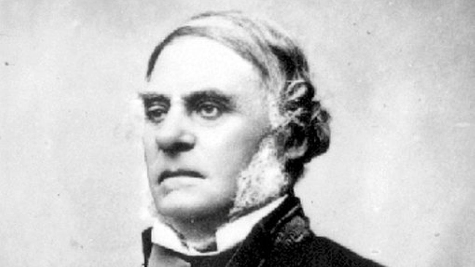 Black and white photograph of an imposing man in formal dress