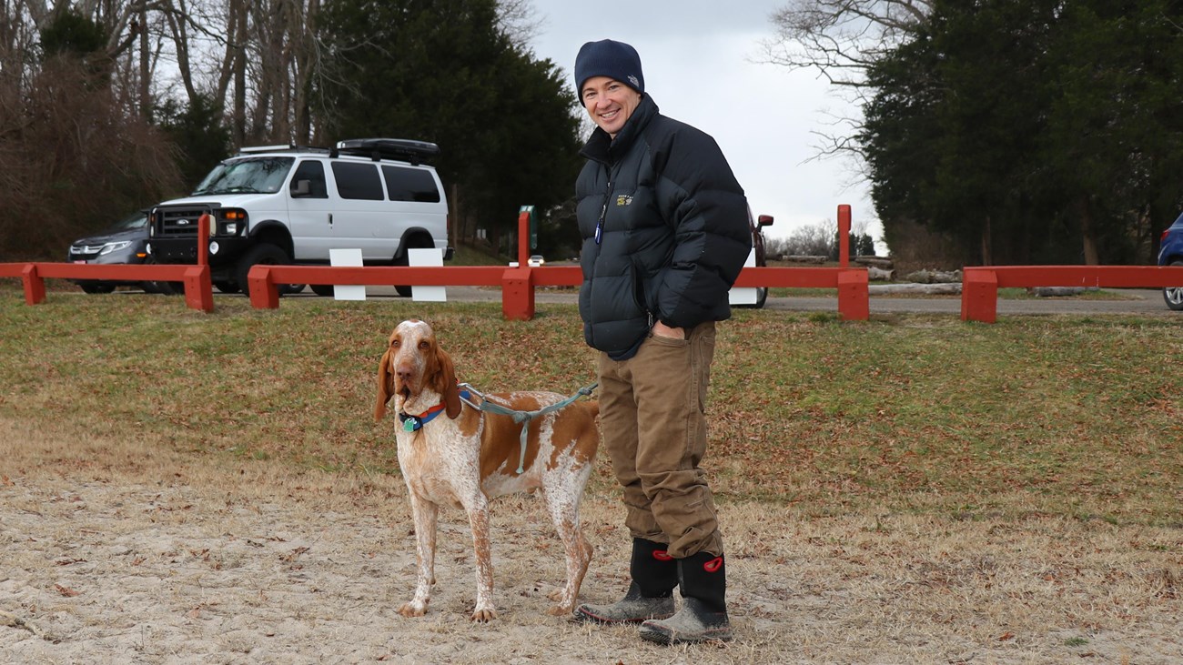 person standing with dog on leash