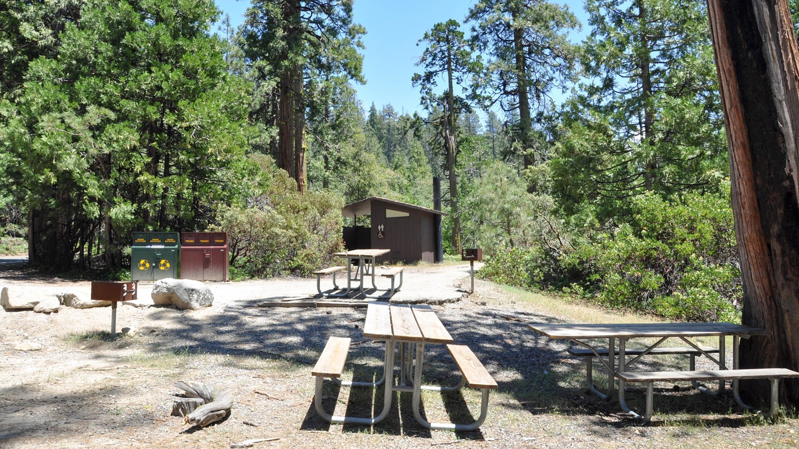 Picnic tables and restroom, grill, and garbage and recycling containers