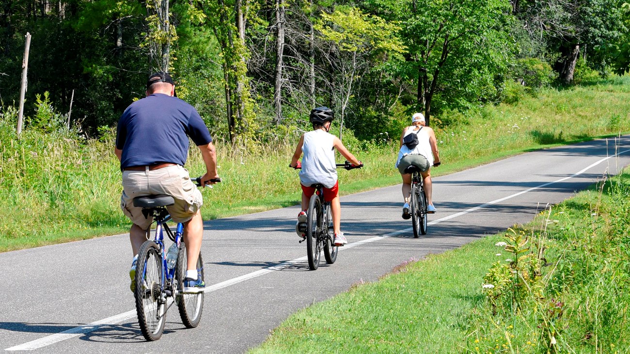 Family of cyclists on paved tour road