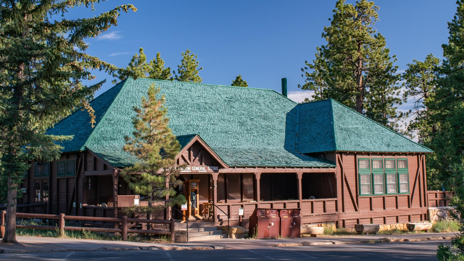 Photo of a large wooden structure with dark green roof.