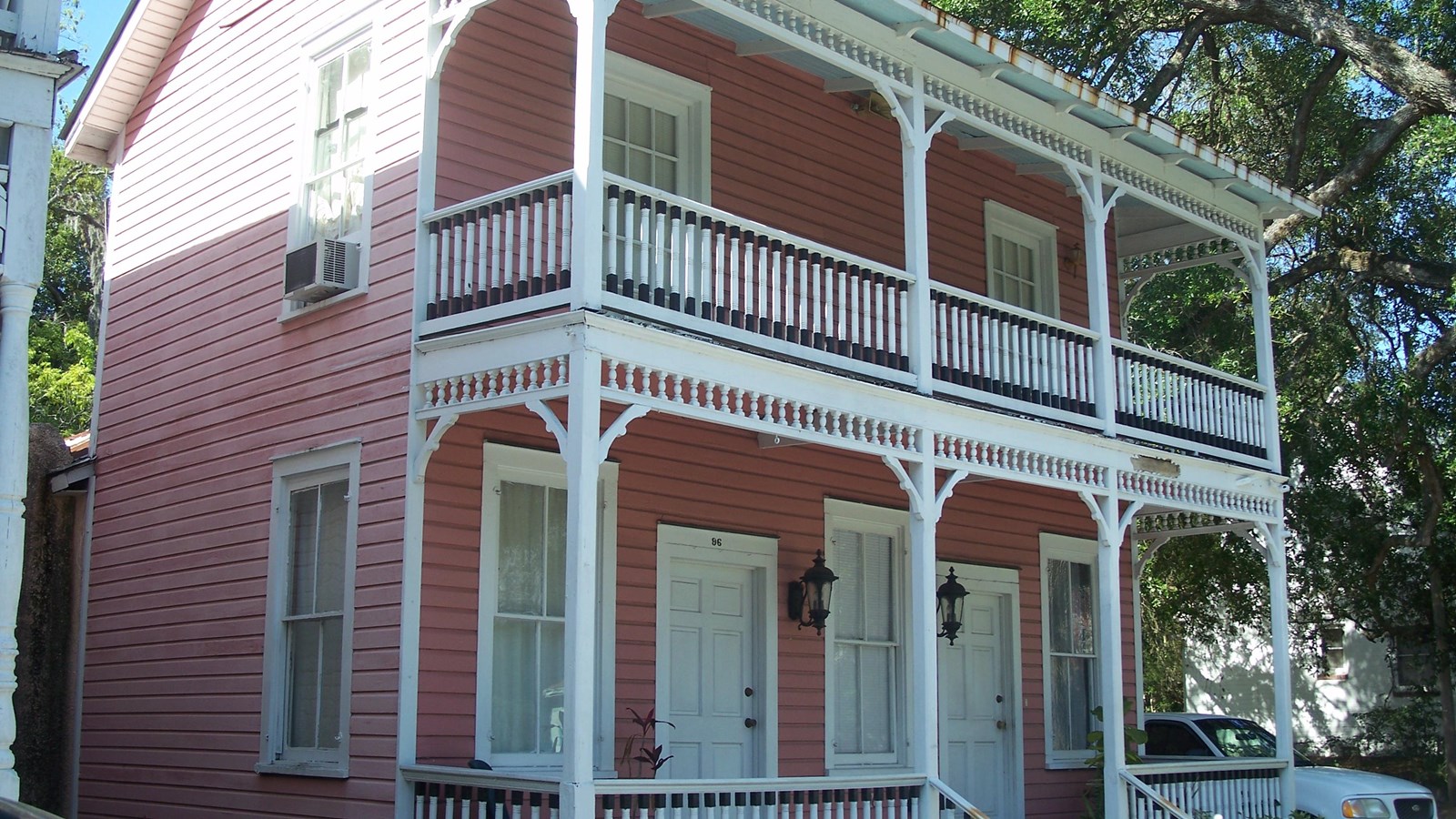 Two-story house with first and second story porch. 