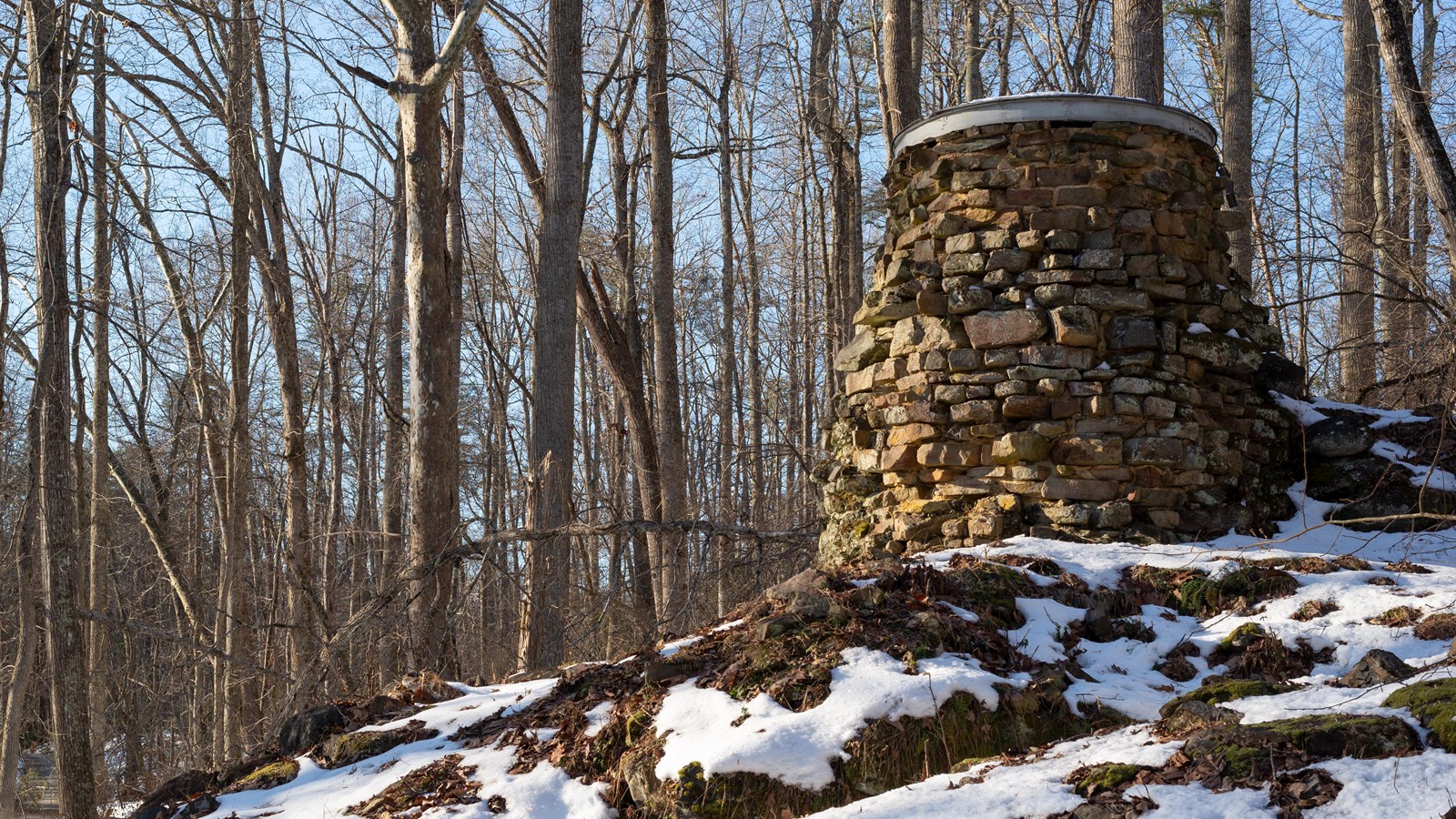 Ruins of a furnace stack, a conical, stone structure, 20 feet high.