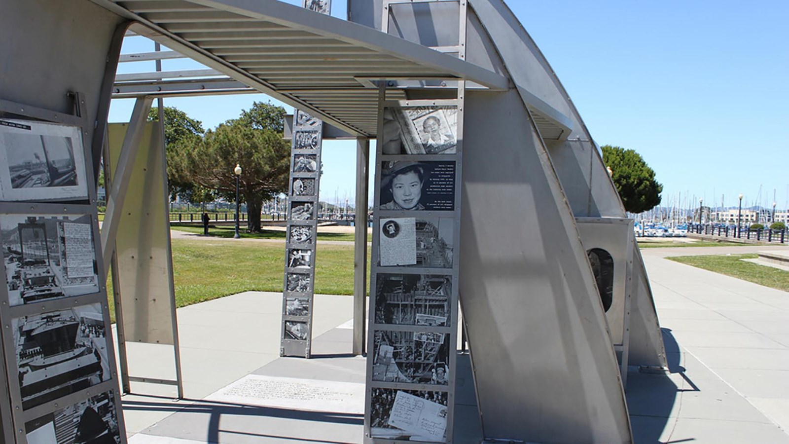 Photo of part of the Rosie the Riveter Memorial, a metalic structure with framed historic images. 