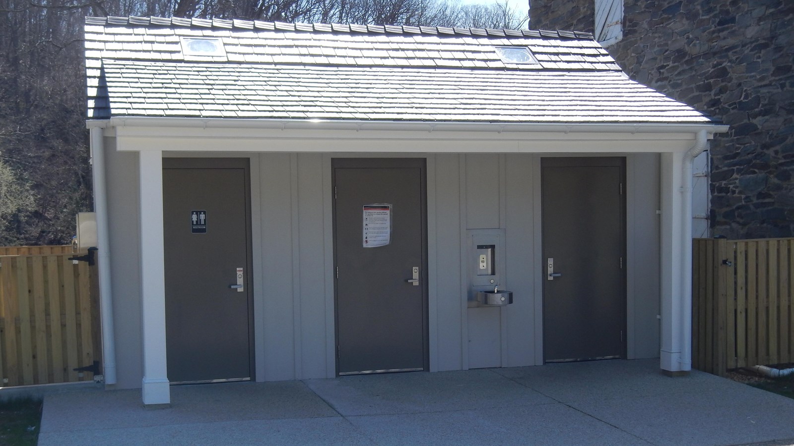 A single story building with three doors.