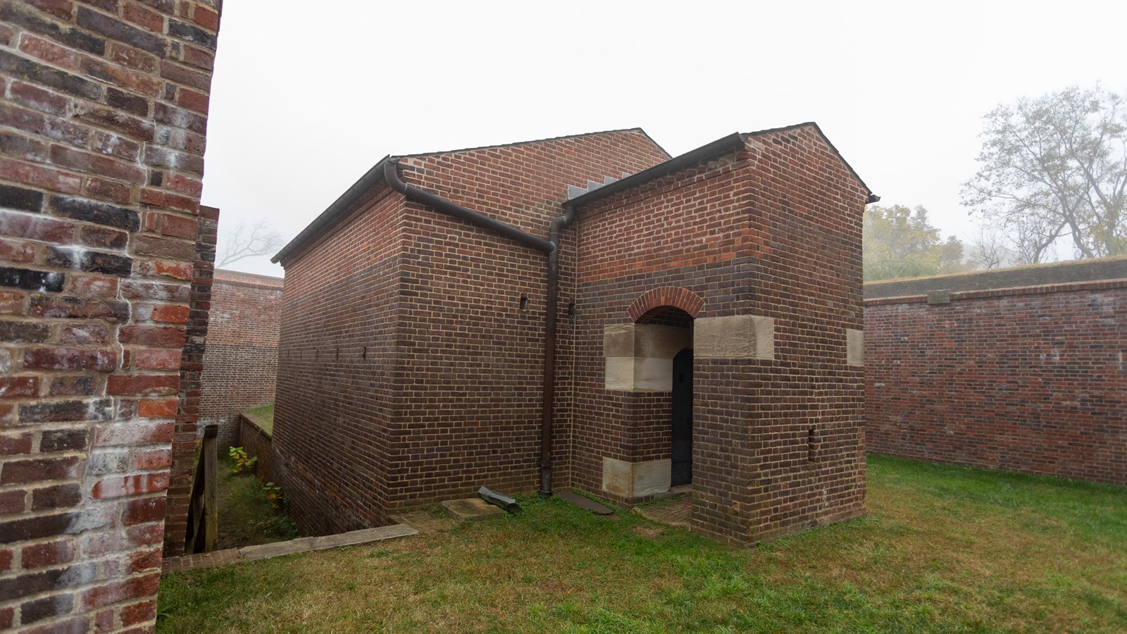 A small brick building with a brick entryway