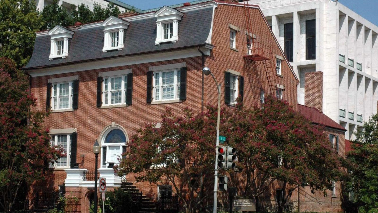 Historic three story brick building on a corner.