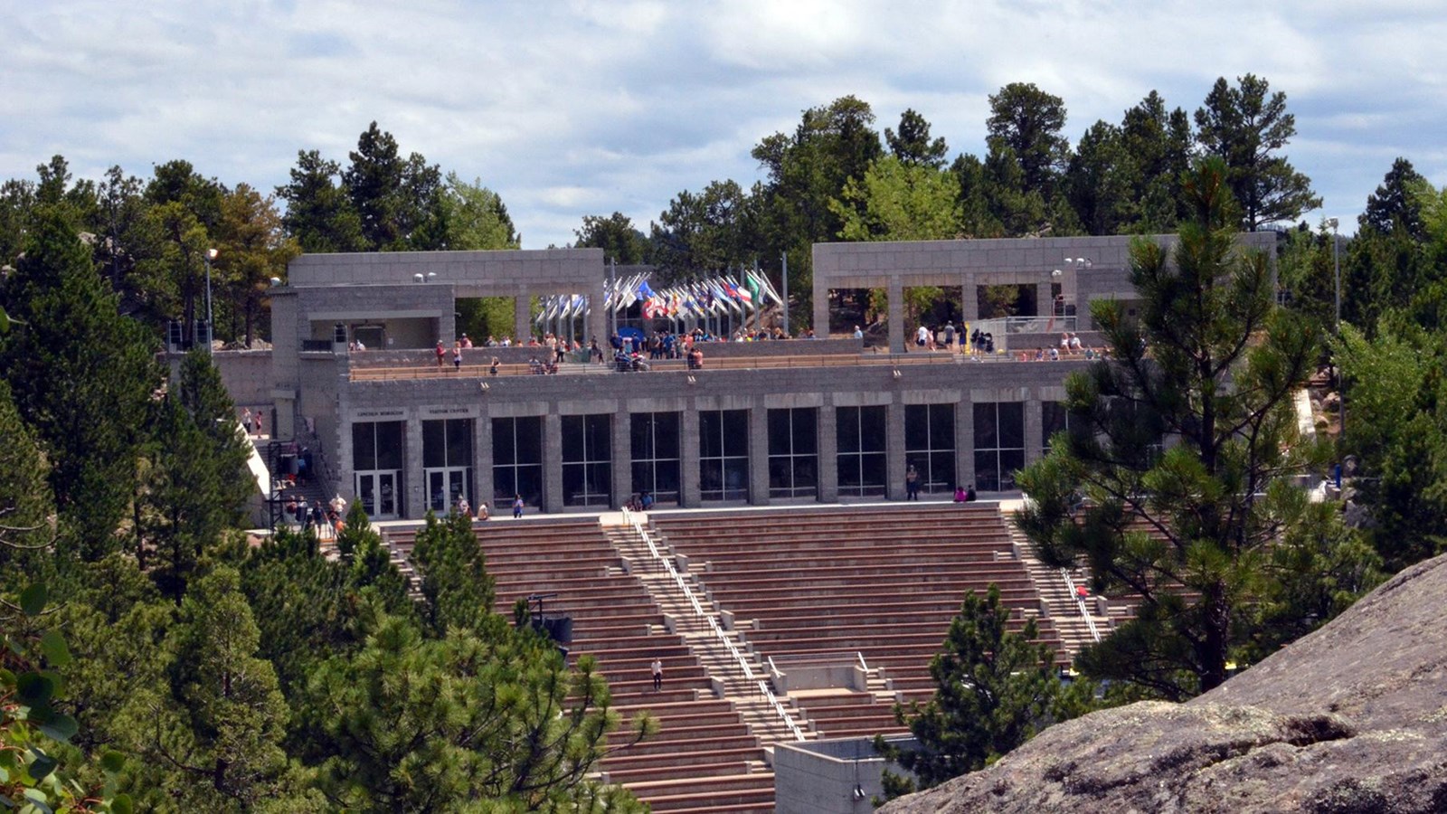 Photo of the exterior of the Lincoln Borglum Visitor Center at the back of the amphitheater seats.