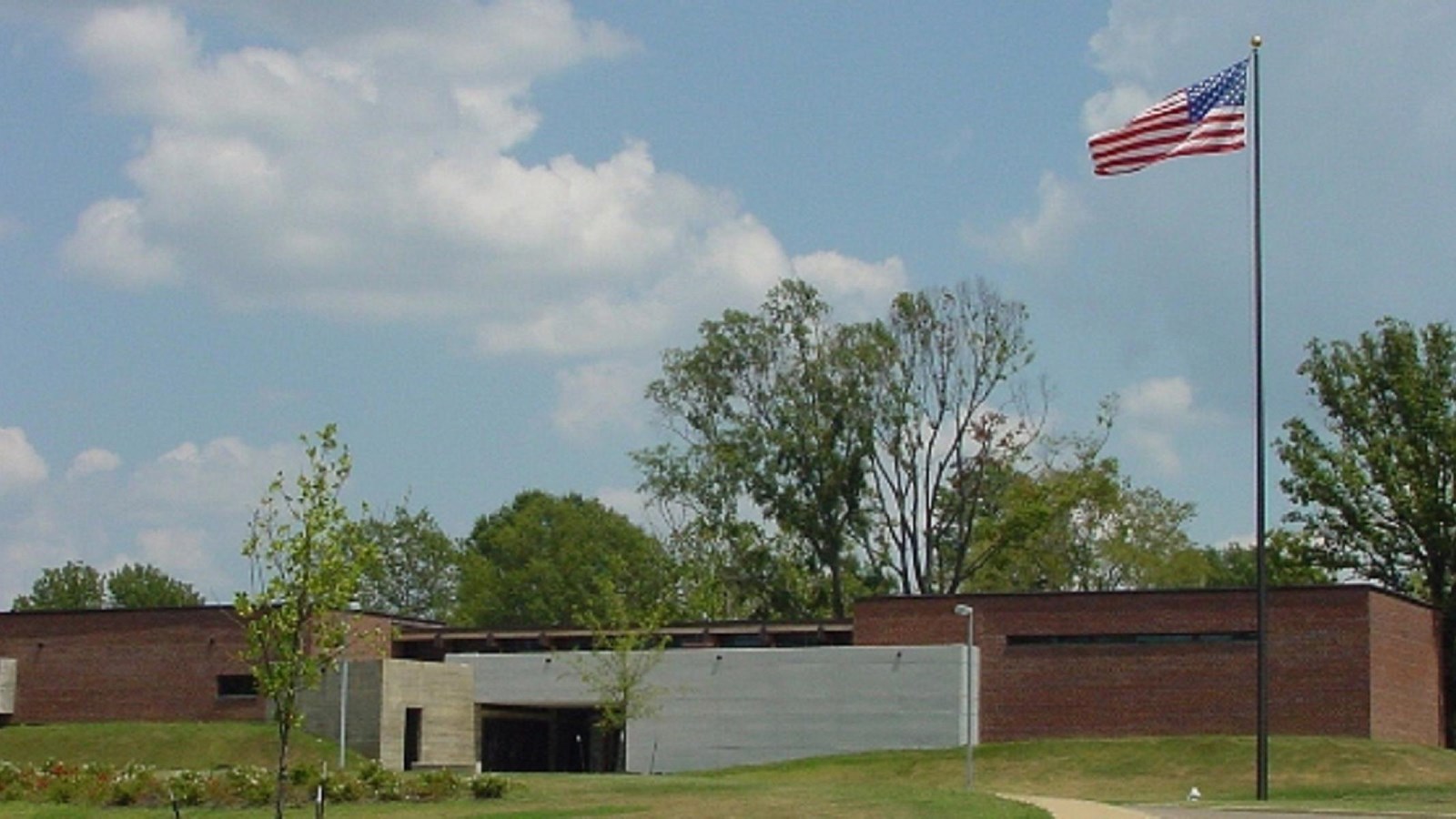 Image of a brick building with American flag flying out front