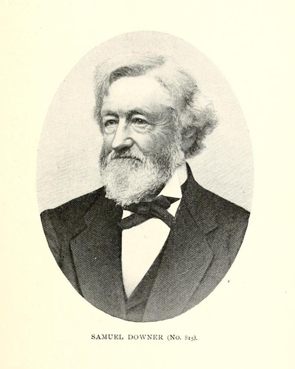 An older man sits looking to his right wearing a black suit with bowtie, from his shoulders up.