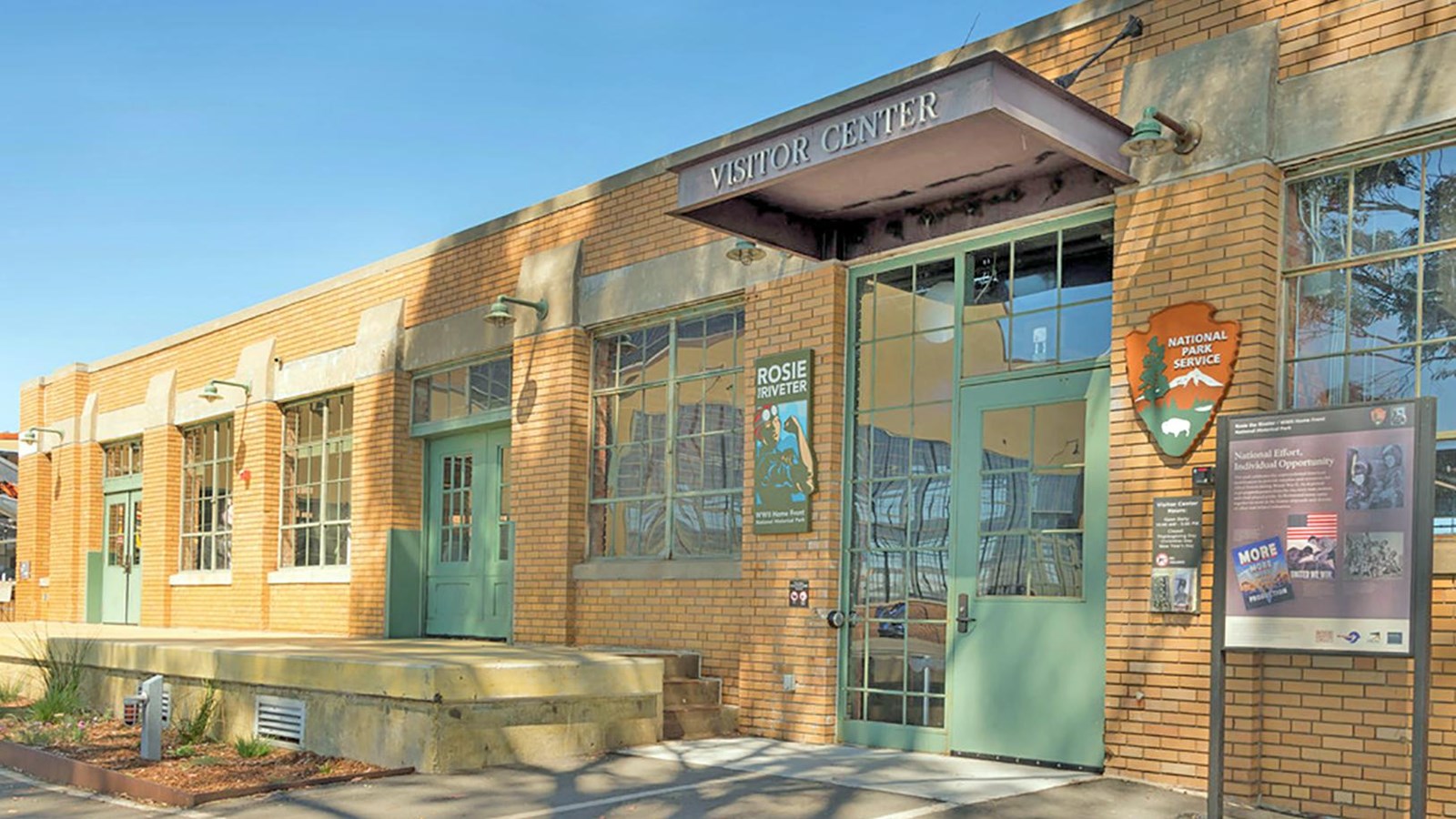 Front of Visitor Education Center. Brick building entrance with park signage.