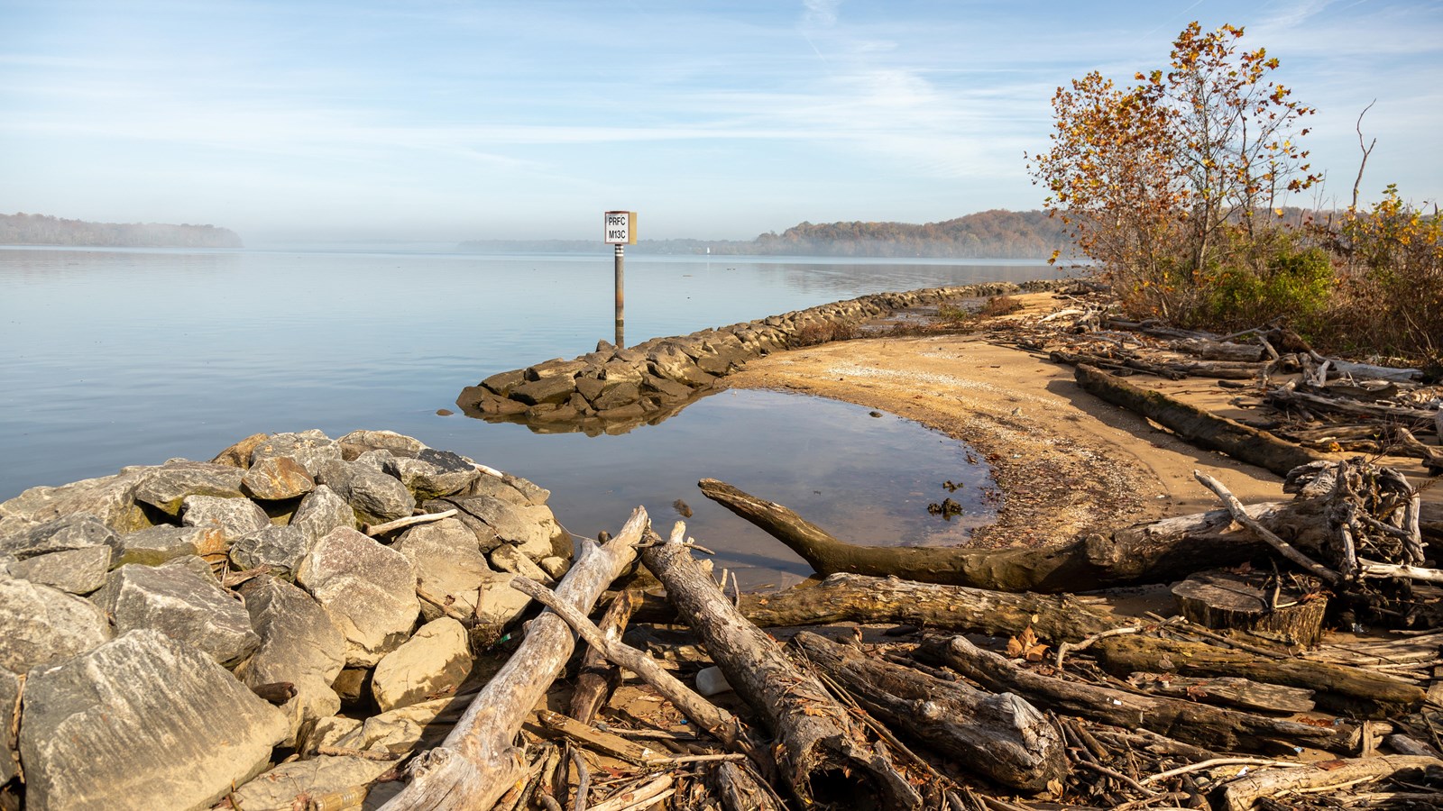 A sandy beach, bordered with large rocks
