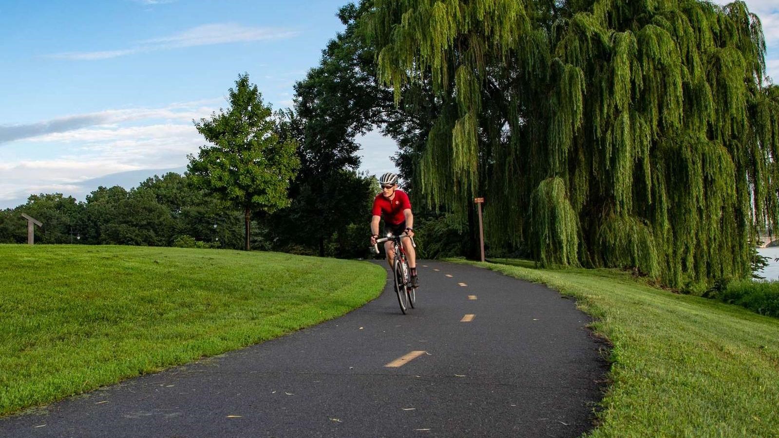 Bicyclist riding on a paved trail