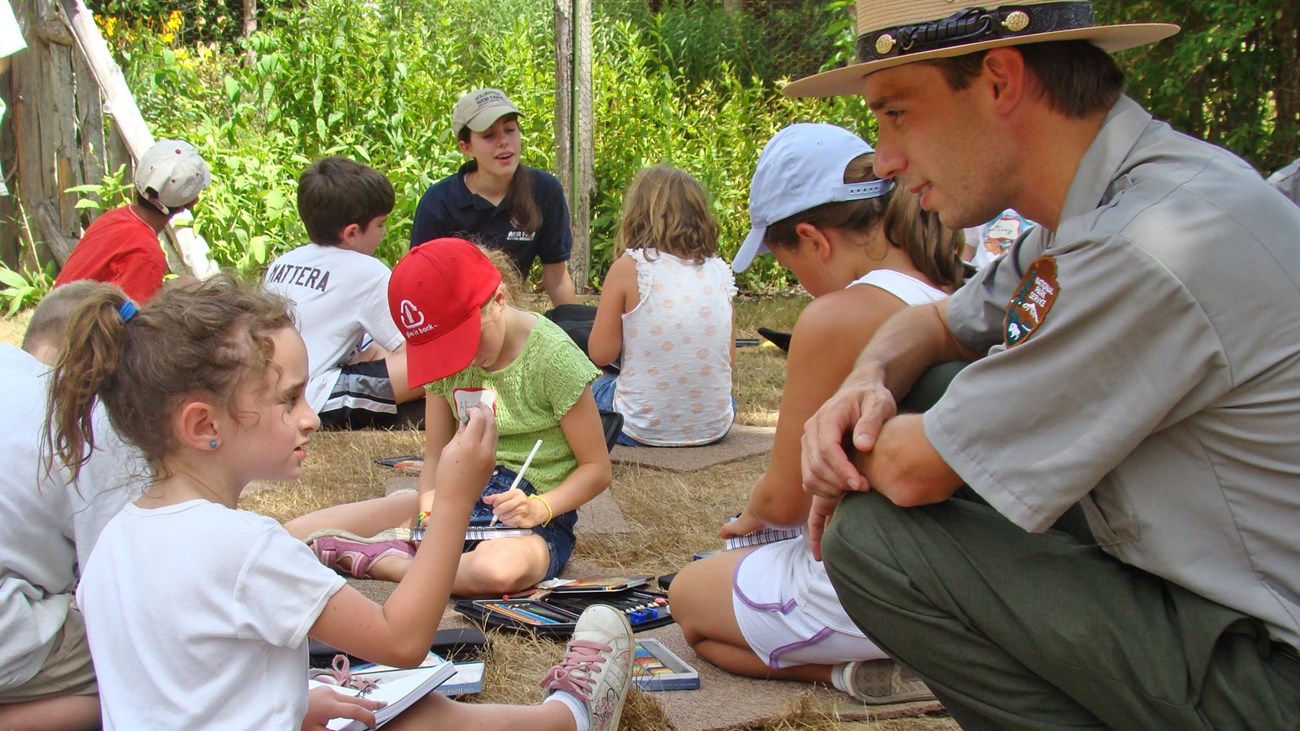 A young girl talking to a Park Ranger.