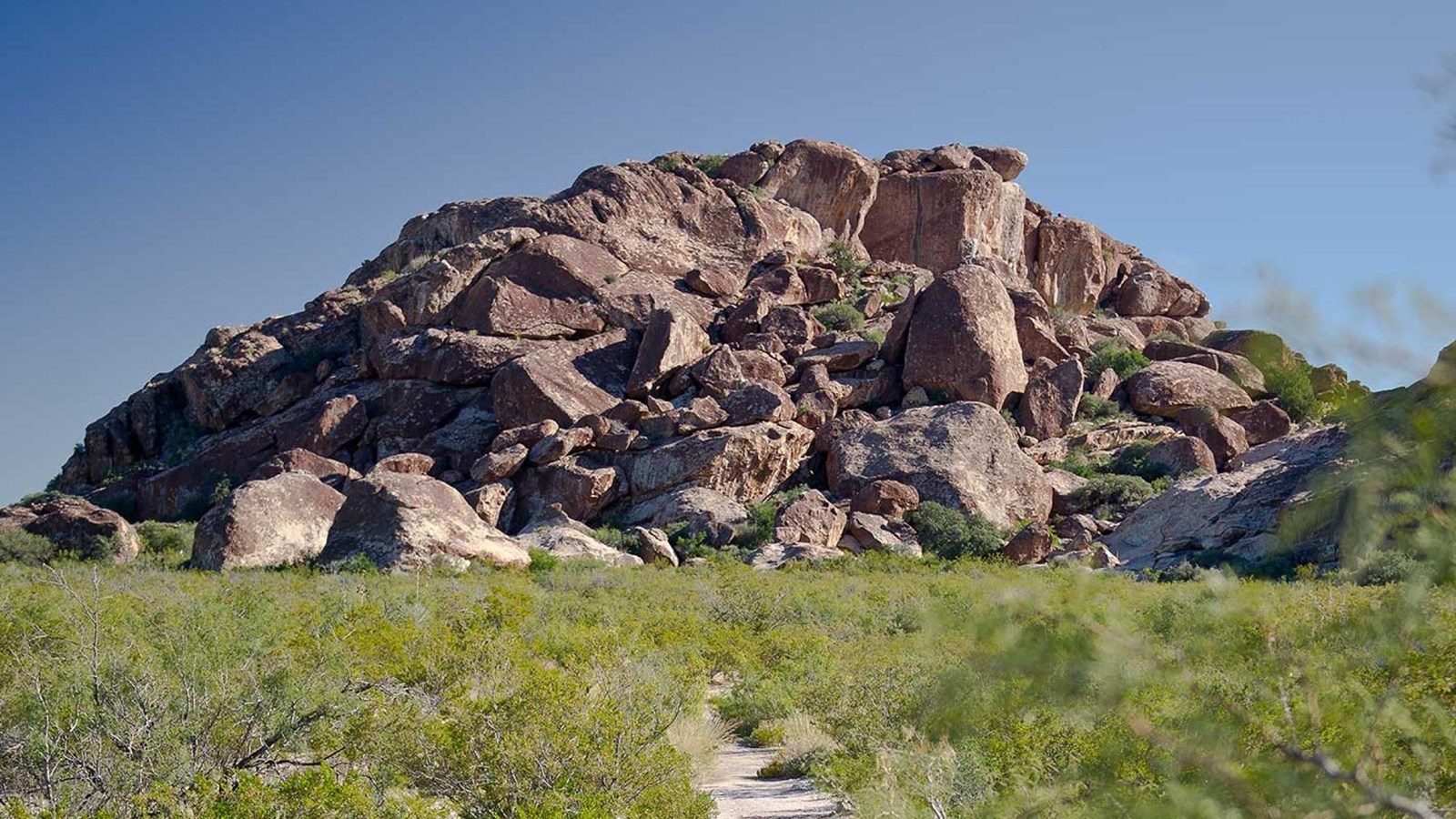 A trail leads to a rock formation