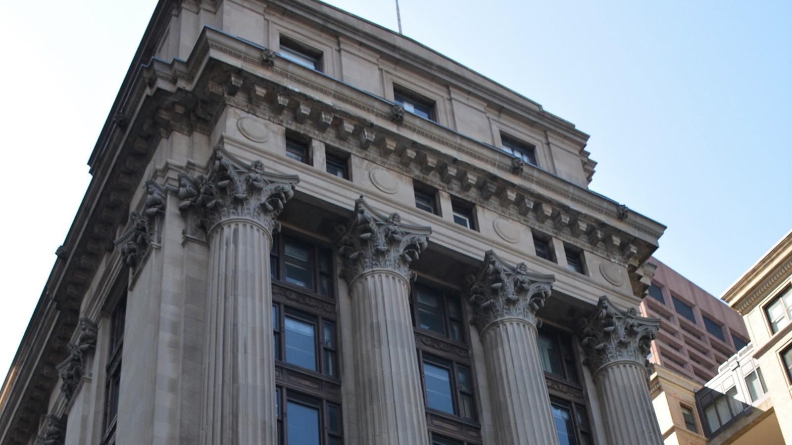 The top of the Boston Courthouse, including the top of Corinthian columns. 