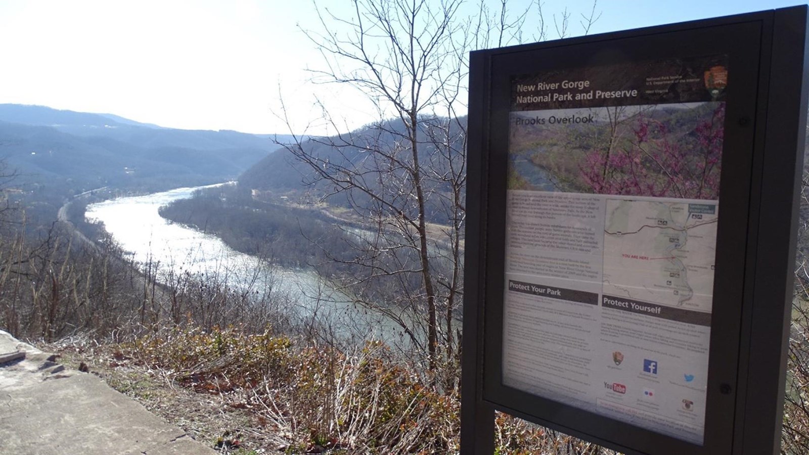 Brooks Island, an island in the river, as seen from the overlook. An info sign is in the foreground.