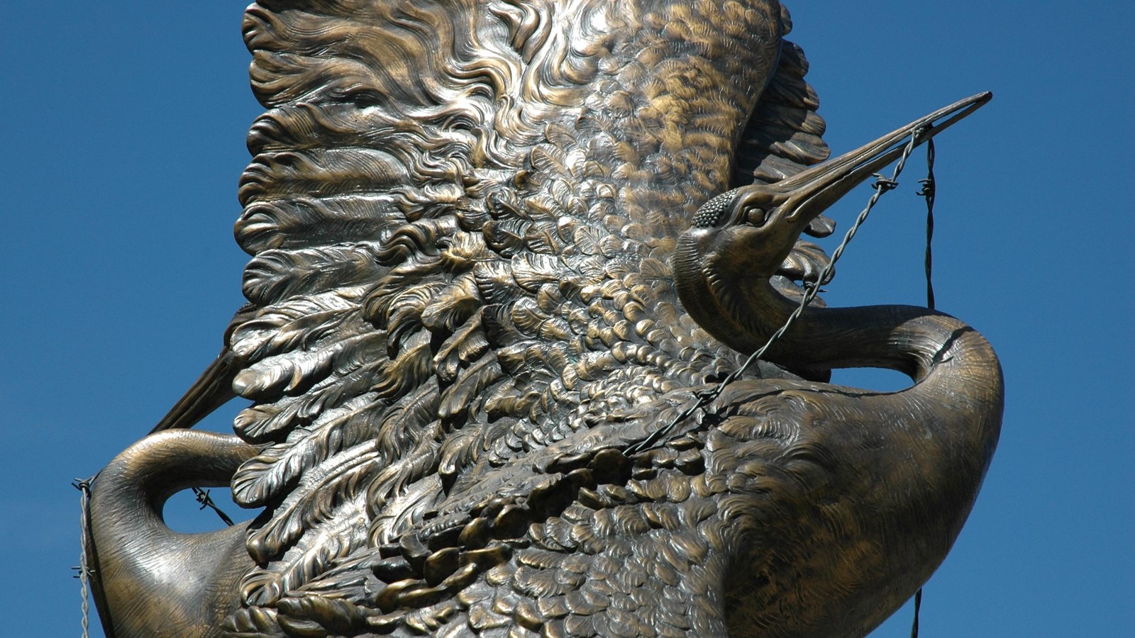 A metal statue of a crane