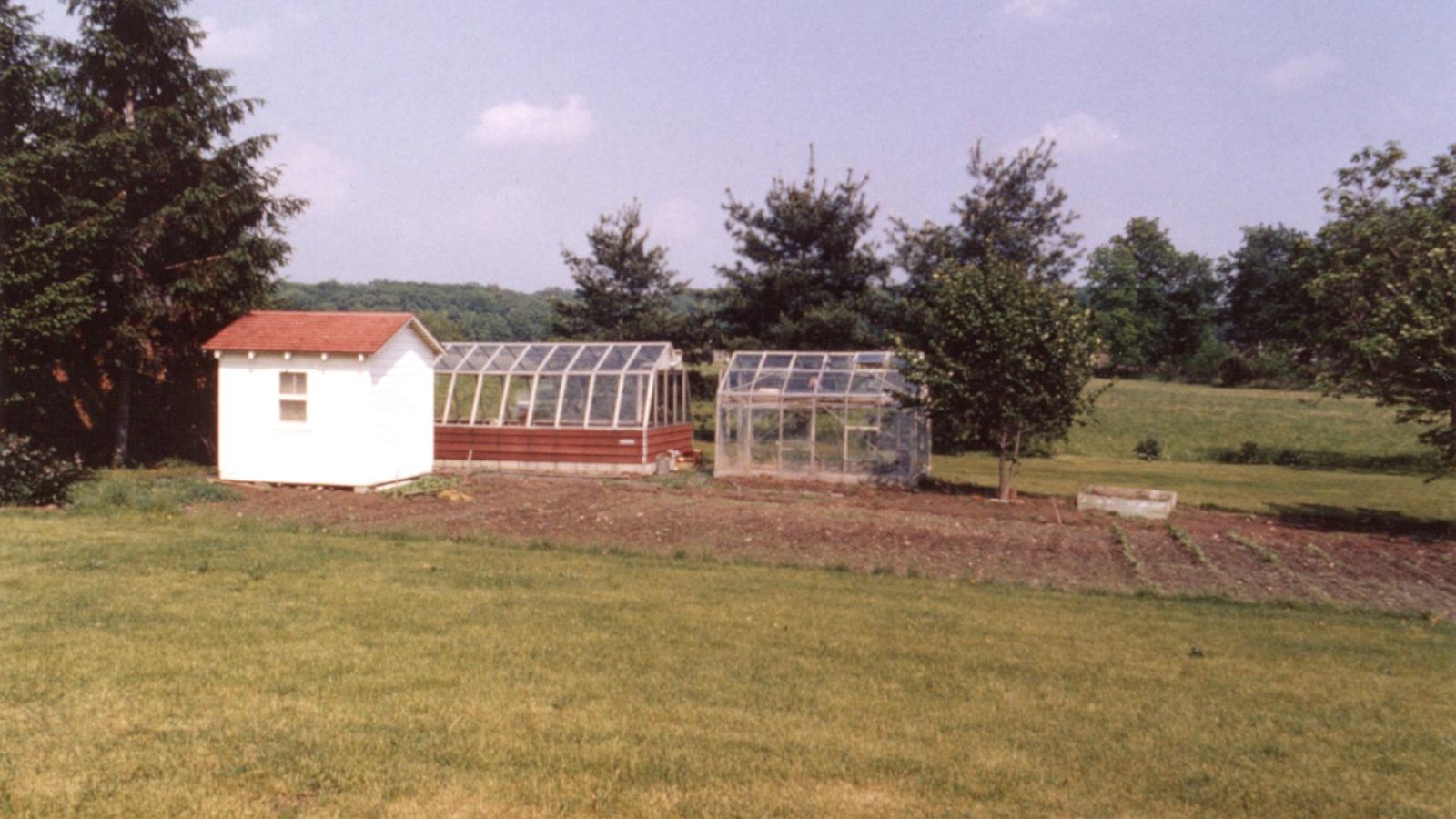 A color image of the gardens, greenhouse, and playhouse on the southern end of the Eisenhower farm.