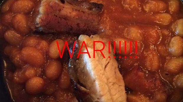 Color photo of stewed pork and beans with the word war superimposed in red letters