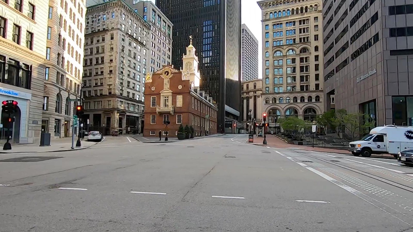 A large street intersection with the Old State House at the top of the street.