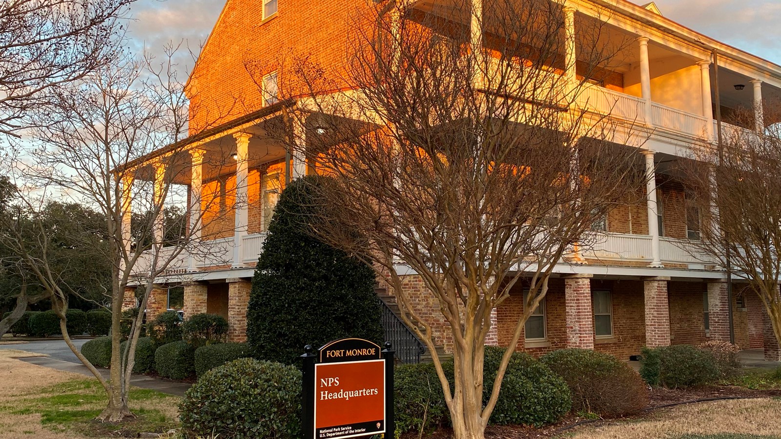 View of Building #17 from the front left corner with building sign in glow of setting sunlight.