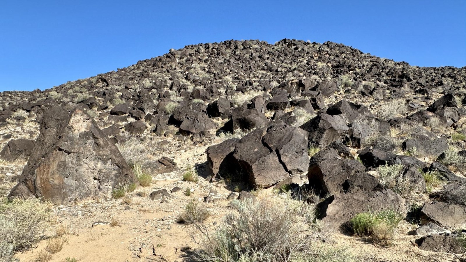 A volcanic landscape under a blue sky/