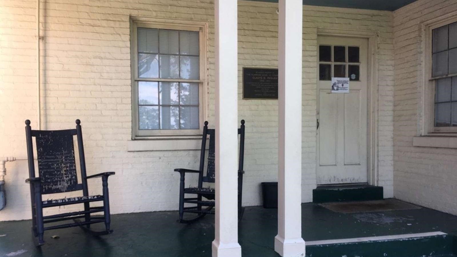 A porch with two rocking chairs