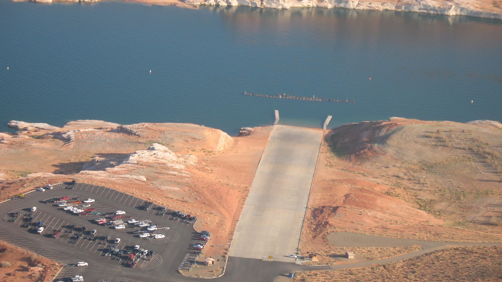 aerial view of long concrete launch ramp and parking lot