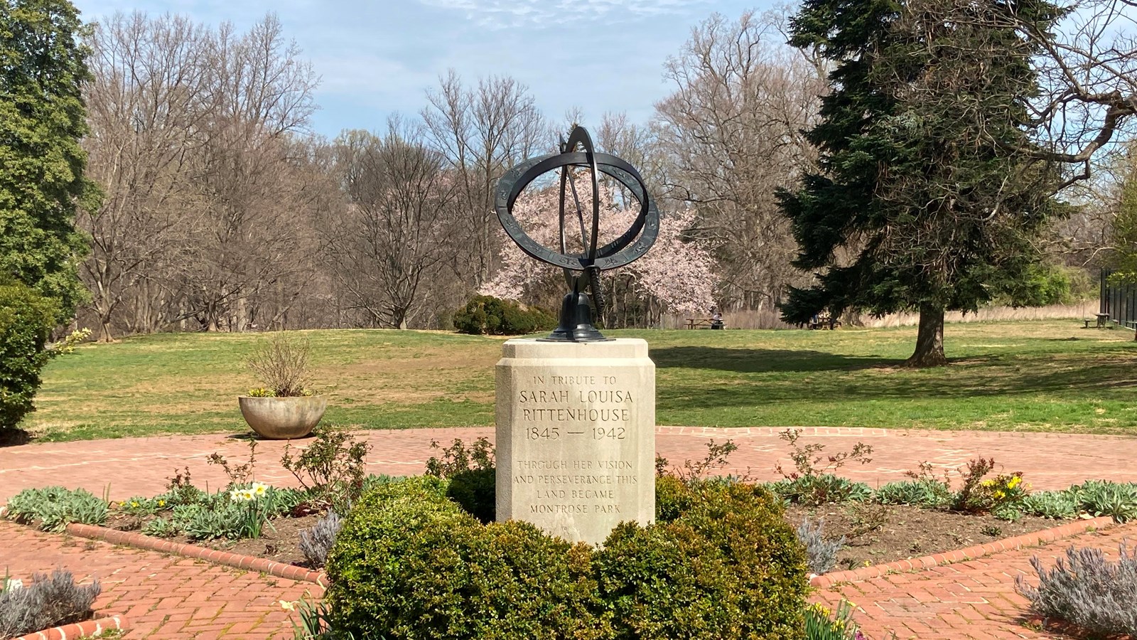 metal astronomical sphere on top of a stone base