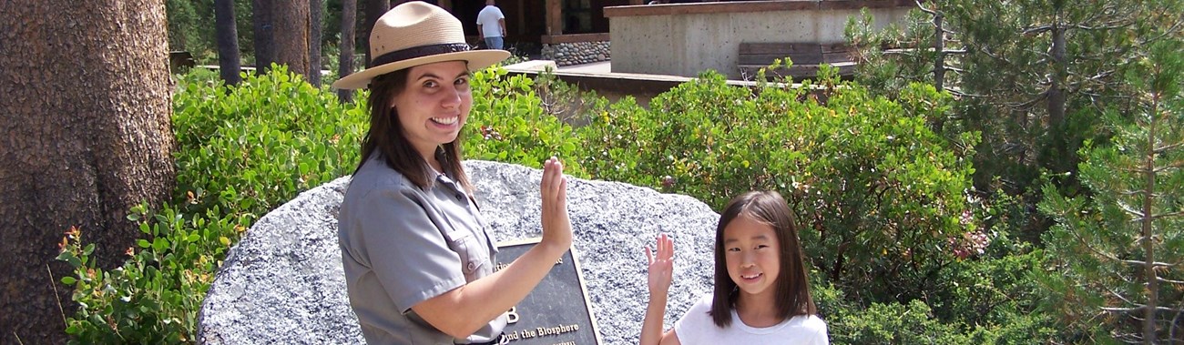 A ranger swears in a child as a Junior Ranger