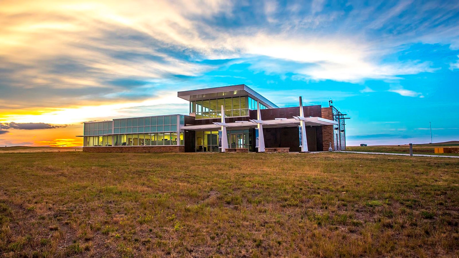 Long and tall building on a prairie landscape at sunset