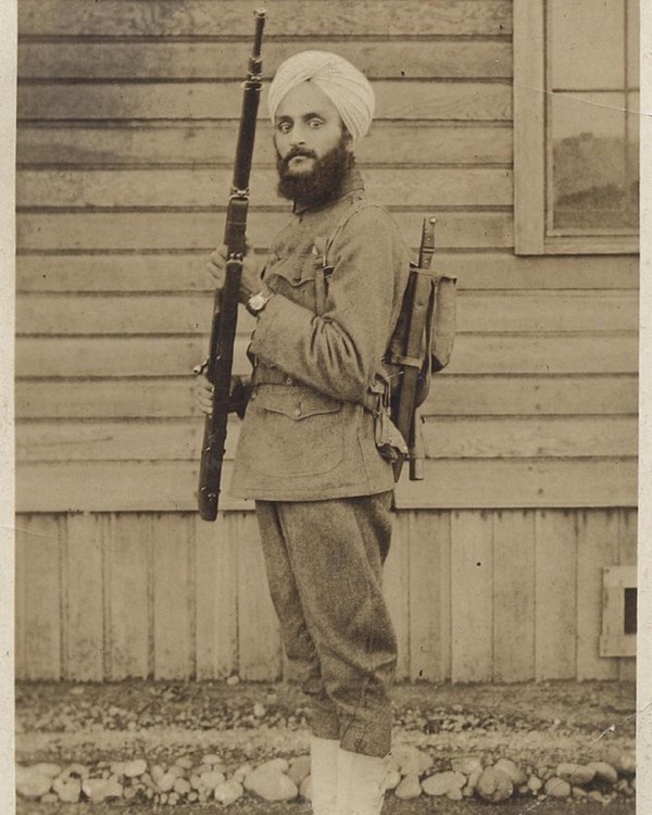 Sepia photo of man with beard and turban wearing military uniform