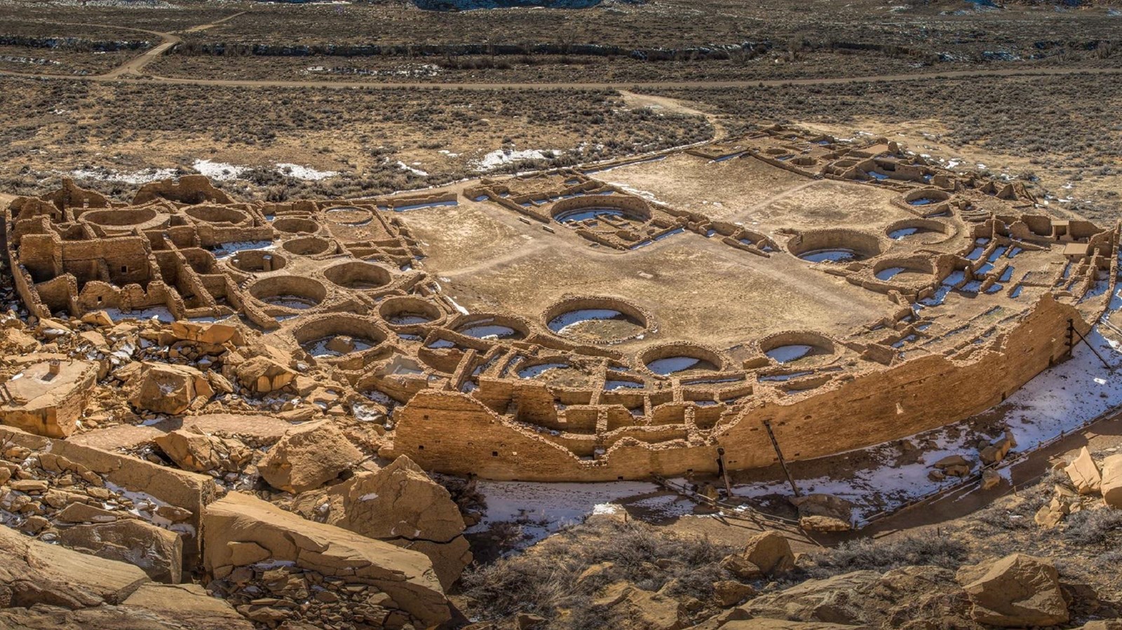An aerial view of the Pueblo Bonito great house showing dozens of open rooms and circular kivas.