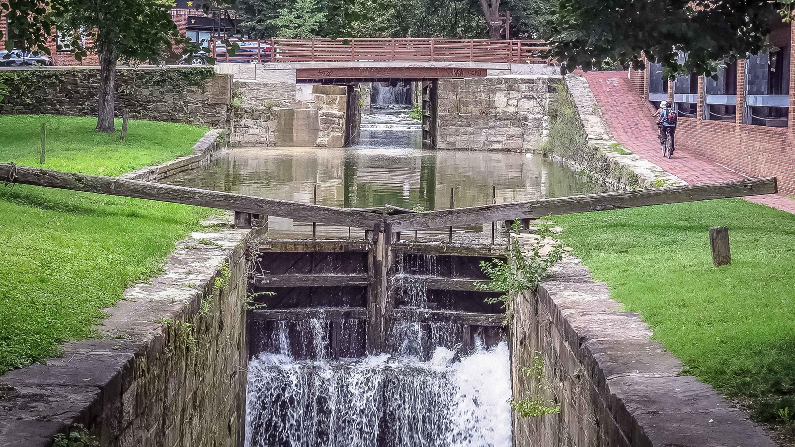 Water flows over the wooden doors of lock 2.