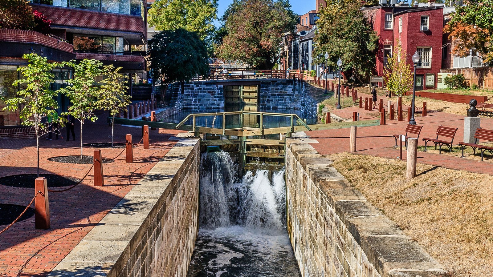 The watered lock sites surrounded by city buildings.