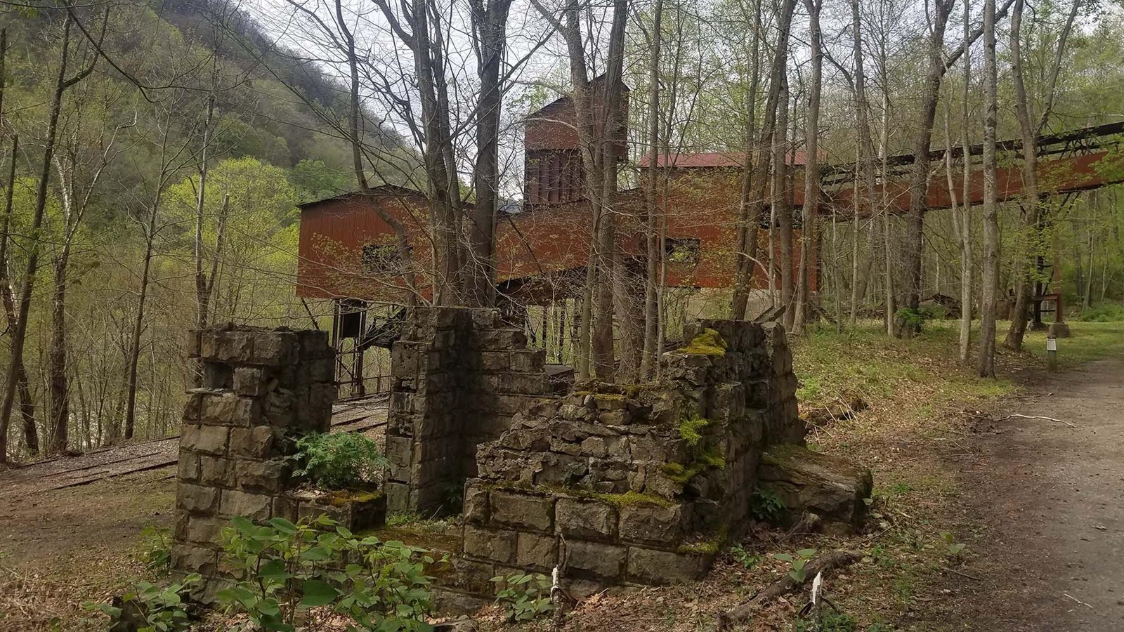 The old reddish-brown coal tipple with a stone foundation below it