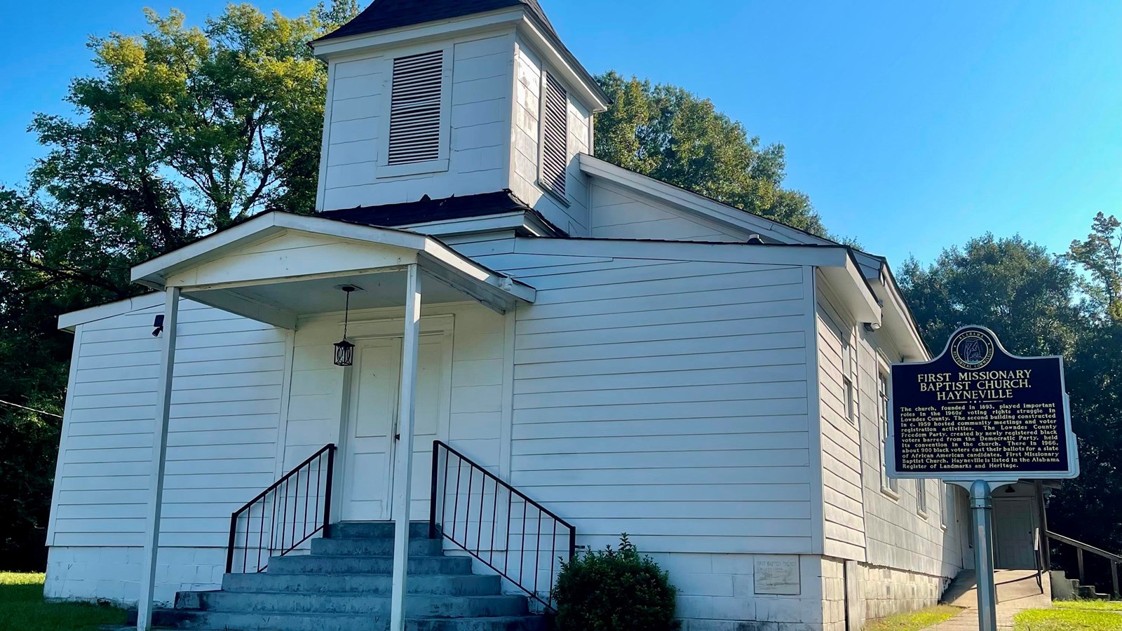 A photo of a church with an Alabama State Historical Marker next to it.